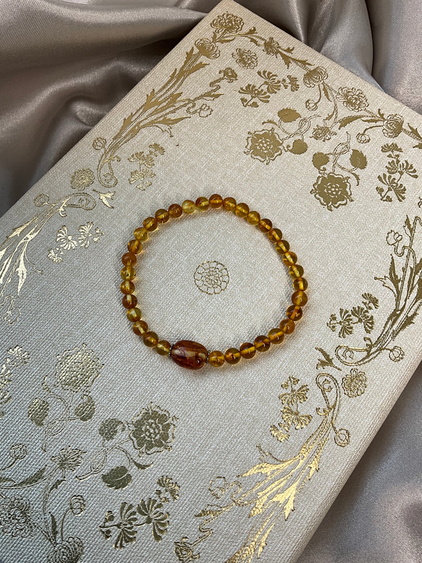 Included Amber stretch bracelet with larger central Amber bead between spacers