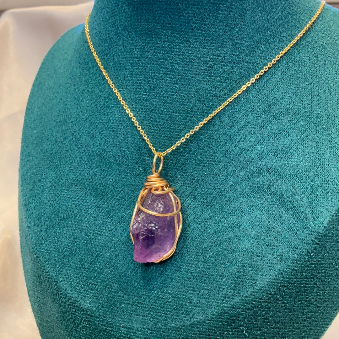 Purple fluorite crystal wire wrapped gold plated pendant on a gold plated chain