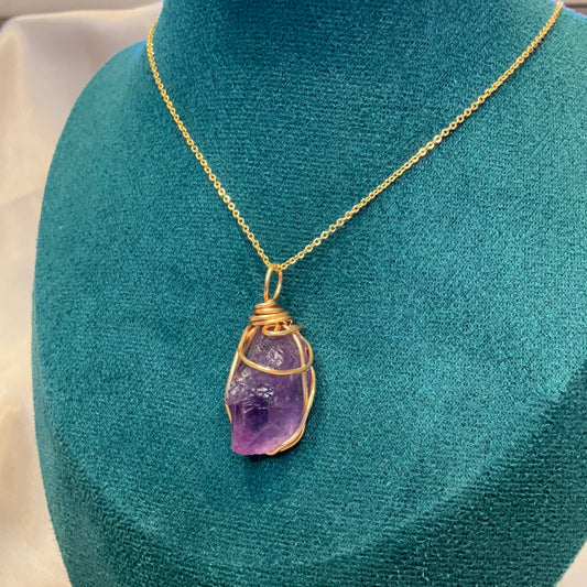 Purple fluorite crystal wire wrapped gold plated pendant on a gold plated chain