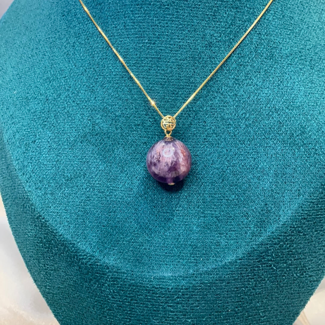 Amethyst with garden quartz co existing sphere pendant on gold plated chain