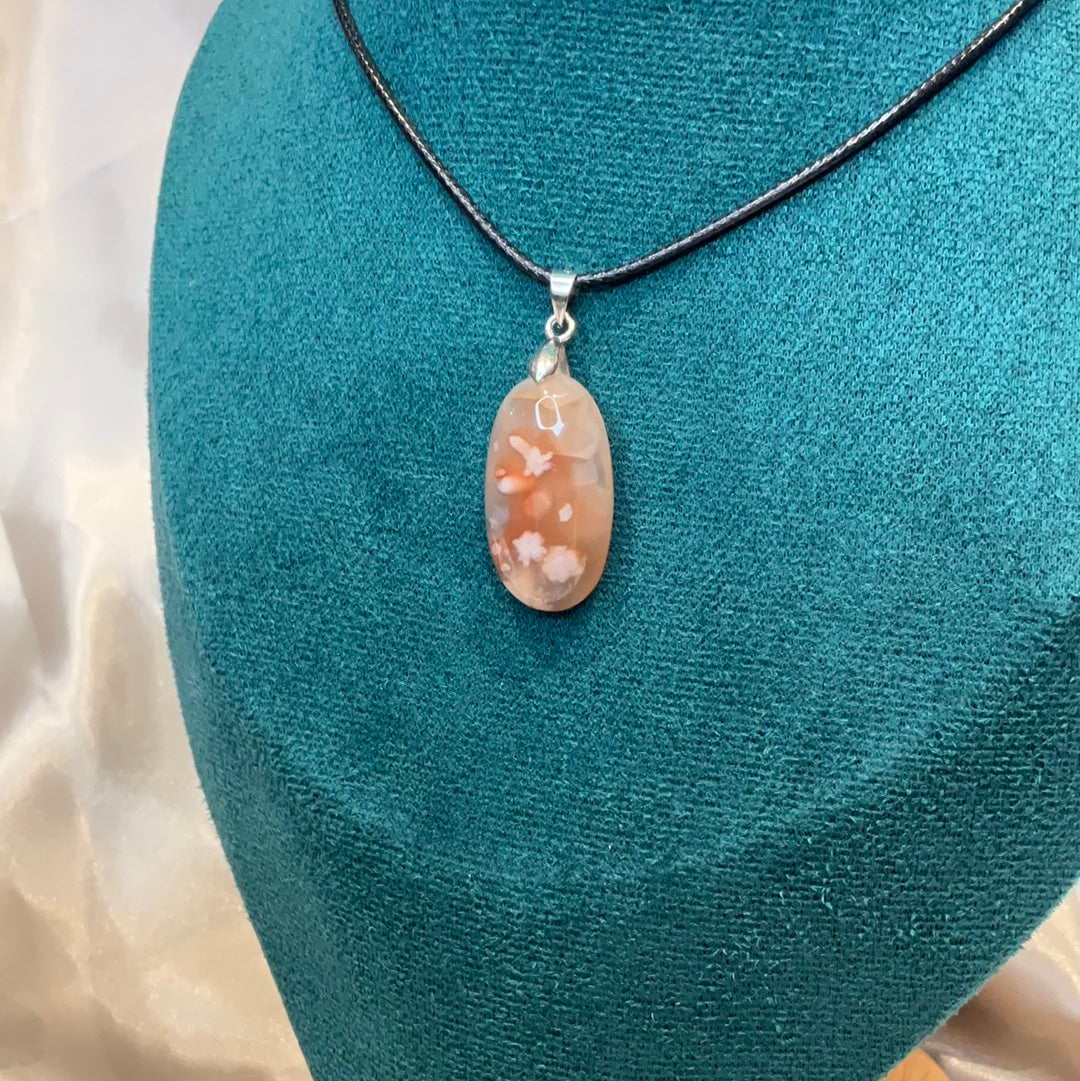 Carnelian flower agate crystal oval pendant on black cord