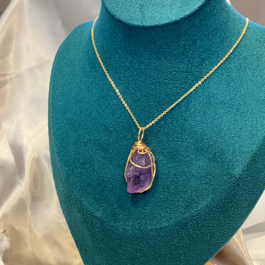 Purple fluorite crystal wire wrapped gold plated pendant on a gold plated chain