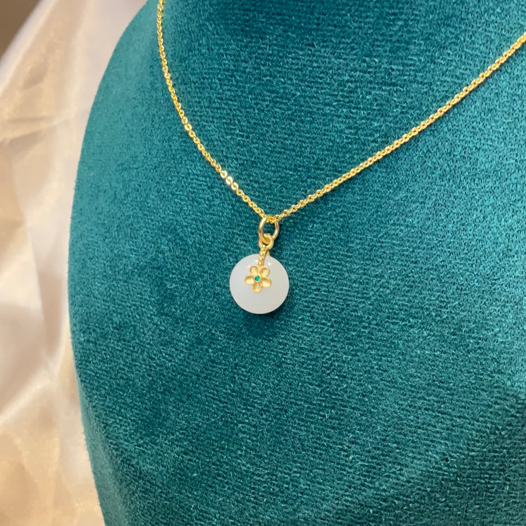 White round pendant on gold plated chain