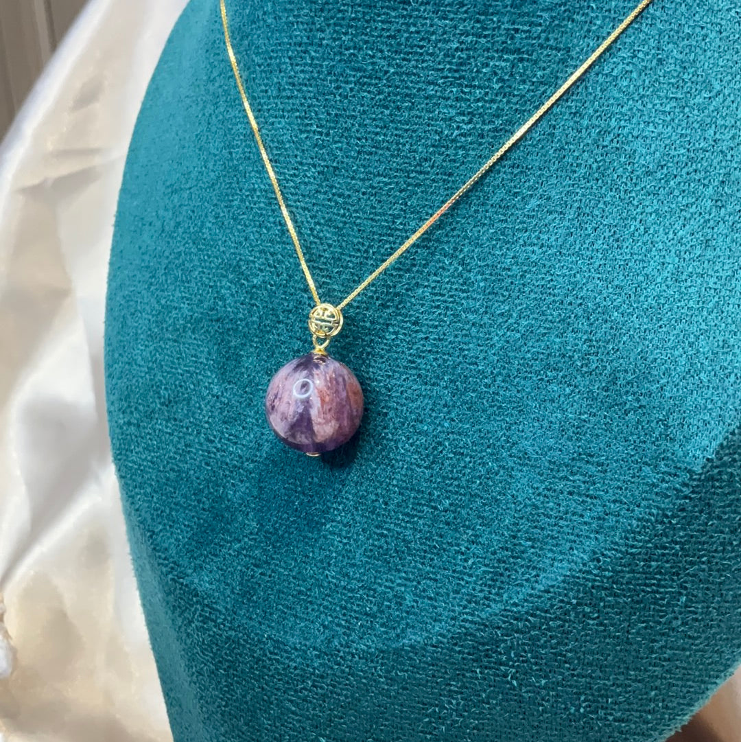 Amethyst with garden quartz co existing sphere pendant on gold plated chain