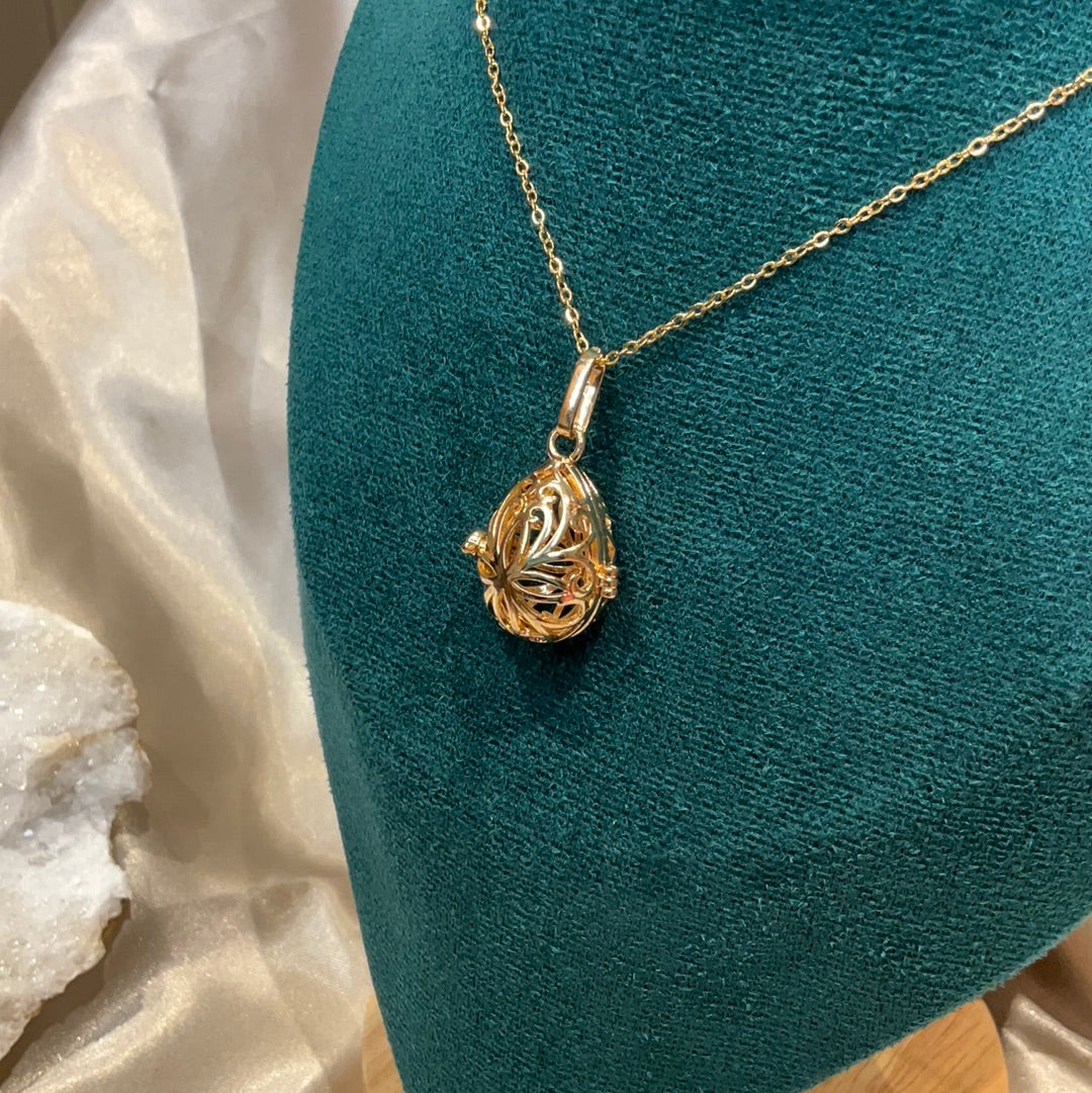 Gold plated cage pendant on gold chain.