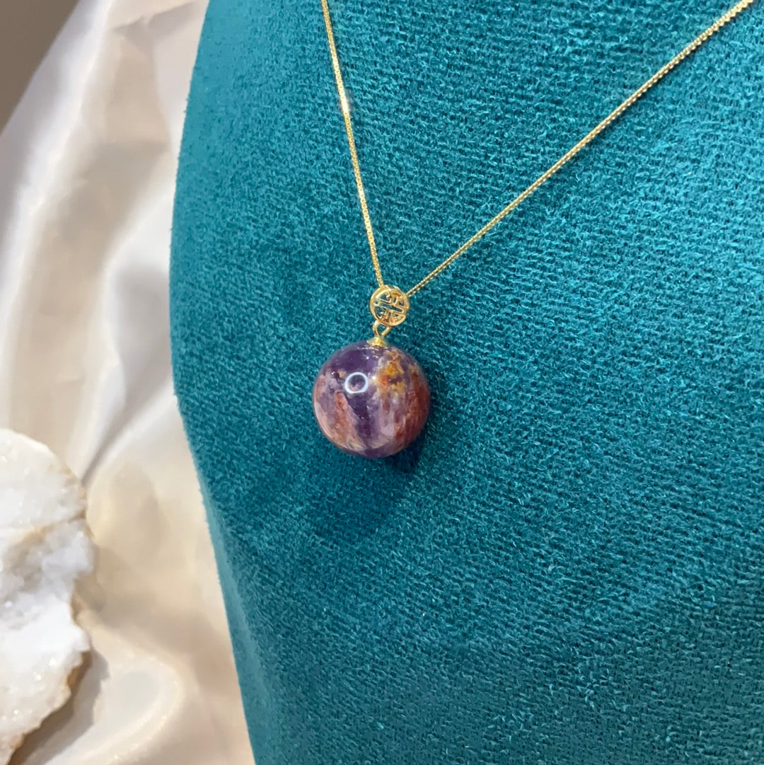 Amethyst with garden quartz co existing sphere pendant on gold plated chain