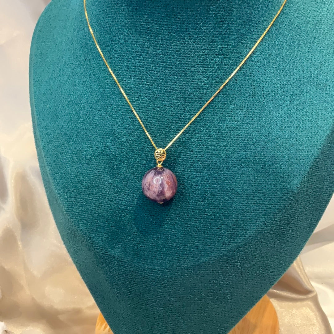 Amethyst with garden quartz co existing sphere pendant on gold plated chain