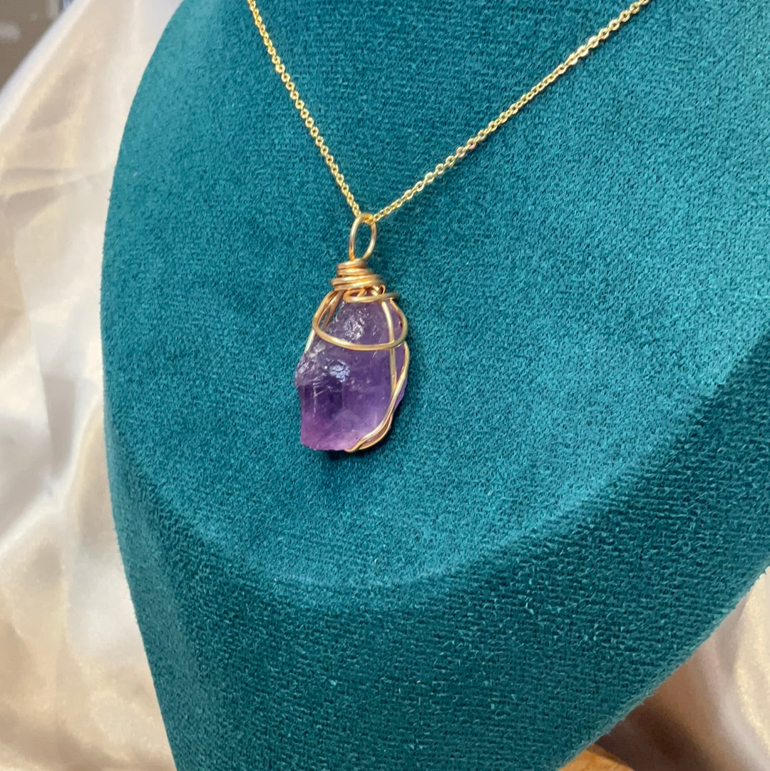 Purple fluorite crystal wire wrapped gold plated pendant on a gold plated chain