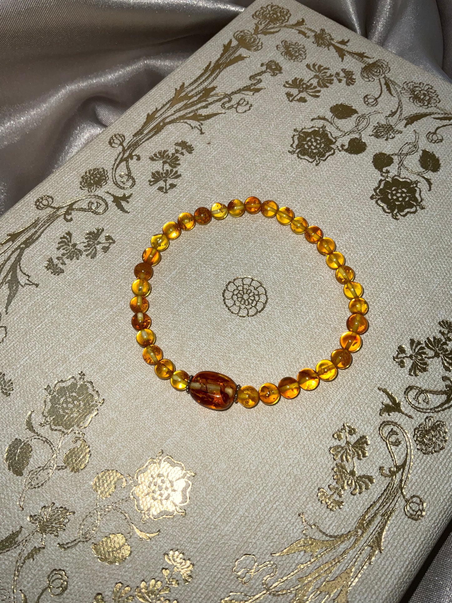 Included Amber stretch bracelet with larger central Amber bead between spacers