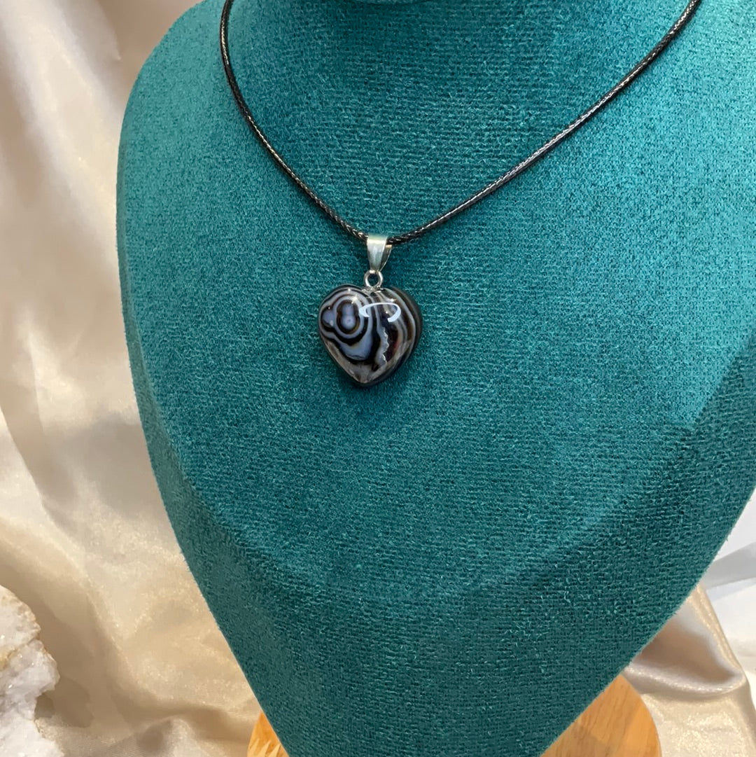 Banded striped Agate heart crystal pendant on black cord.