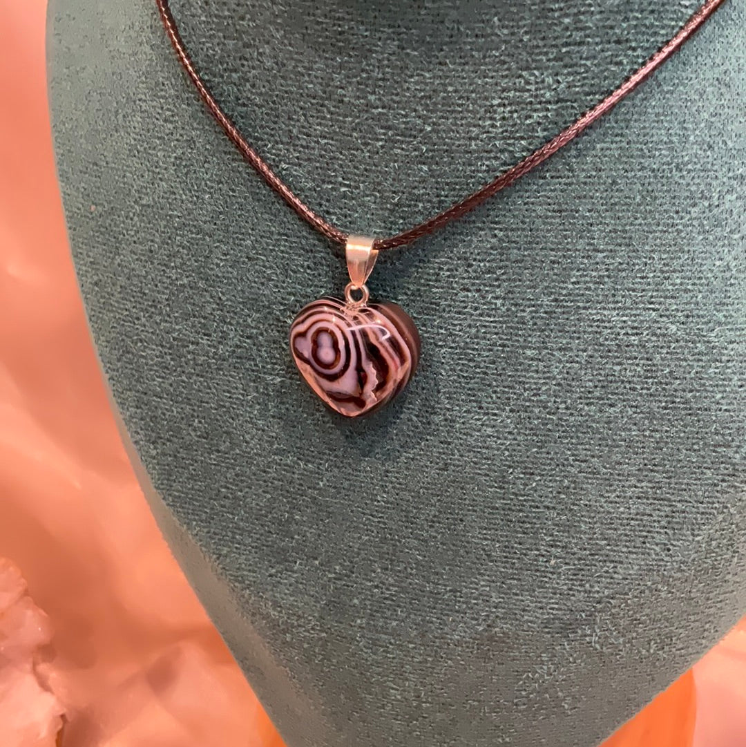 Banded striped Agate heart crystal pendant on black cord.