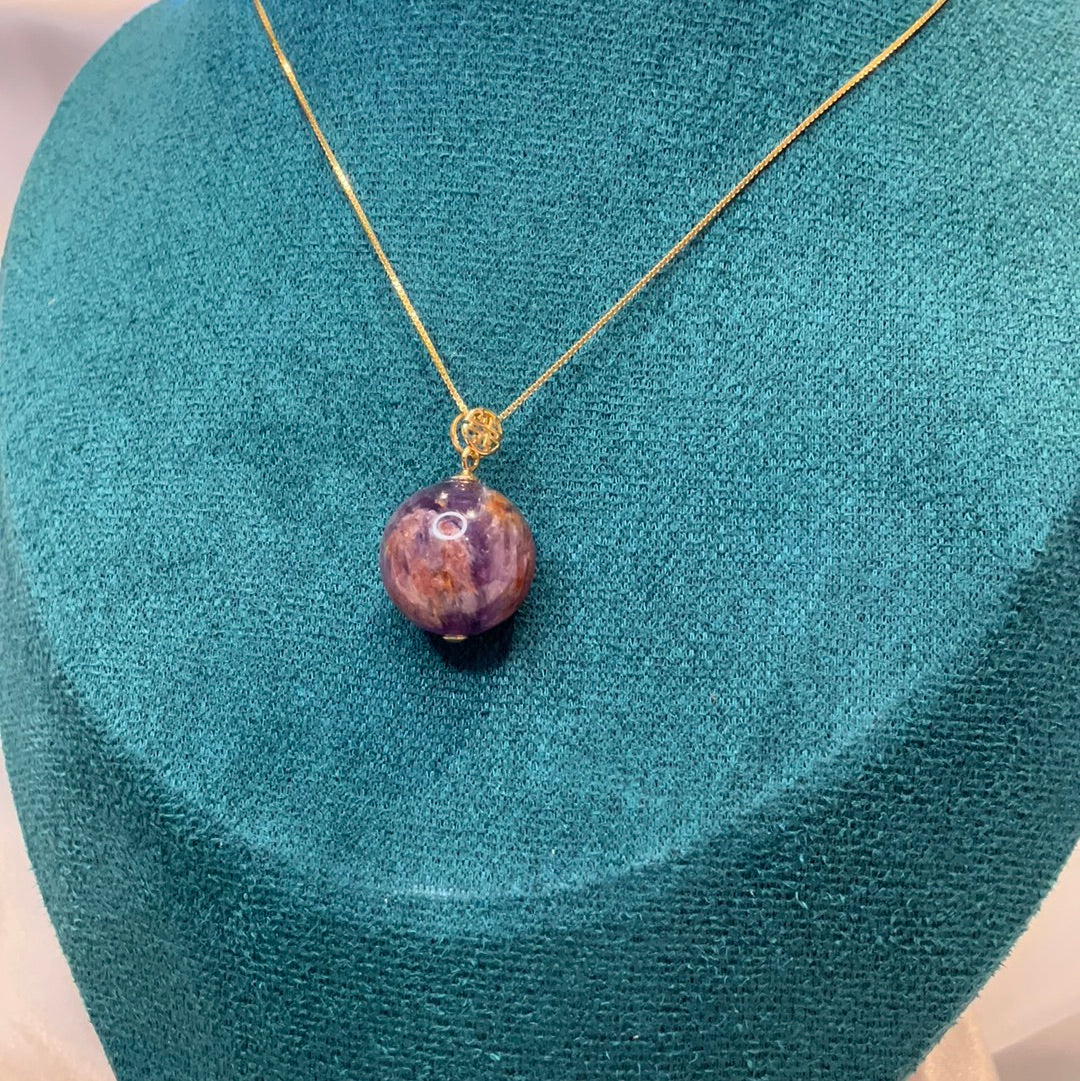 Amethyst with garden quartz co existing sphere pendant on gold plated chain