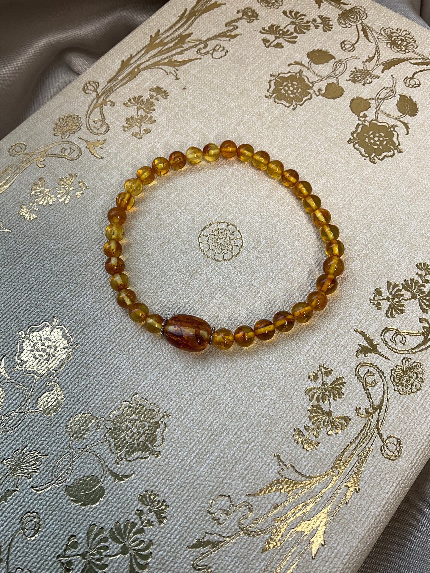 Included Amber stretch bracelet with larger central Amber bead between spacers