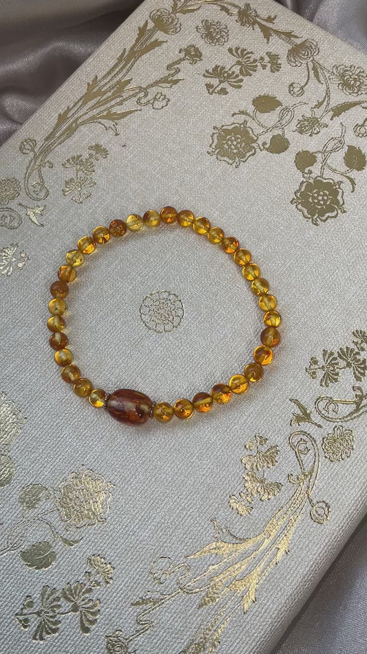 Included Amber stretch bracelet with larger central Amber bead between spacers